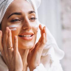 Woman putting on face cream