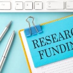 Clipboard with the paper with the words "Research funding" 